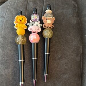 Animal-Themed Black and Gold Pens